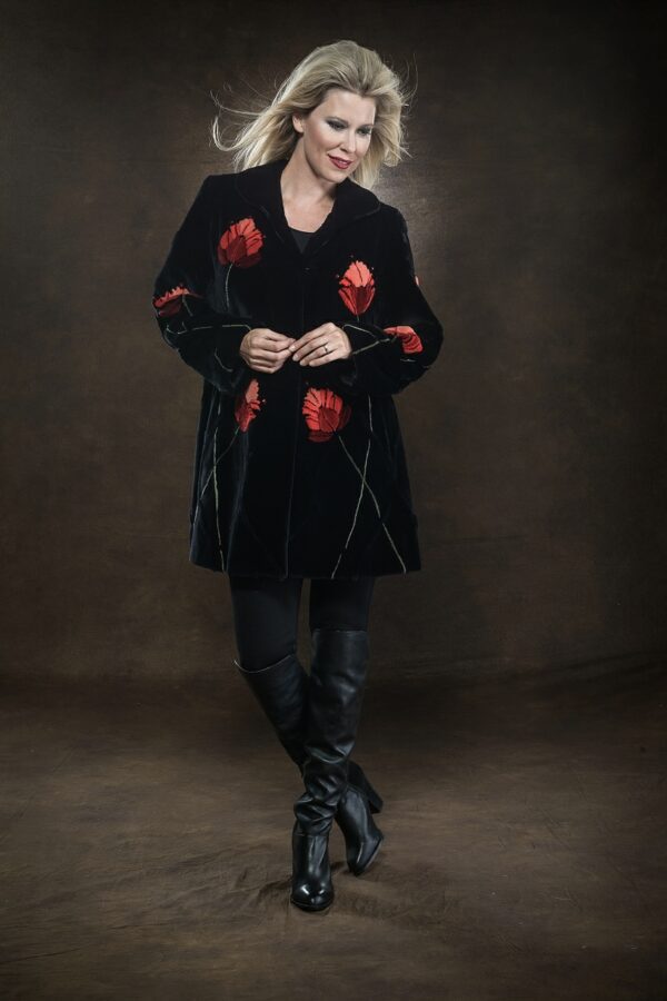 • woman wearing black fur coat with red floral design