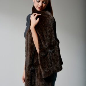 woman with makeup and ponytail modeling knit fur coat