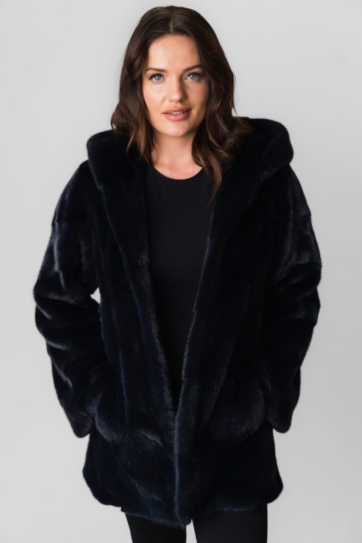 A Woman Wearing a Velvet Texture Black Standard Length Coat