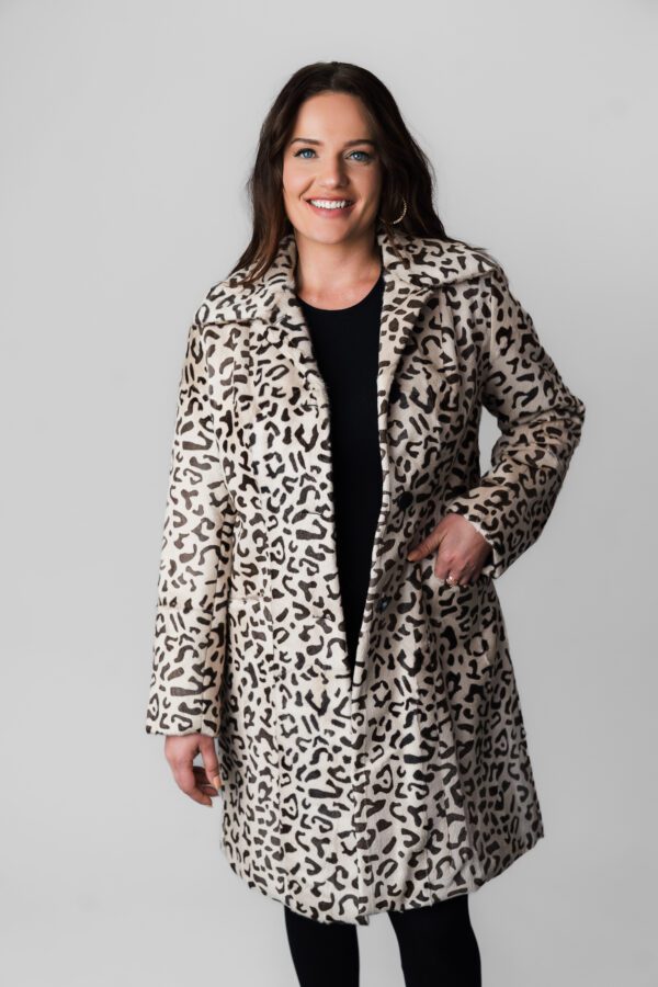 A Woman in a White Color Long Coat With Leopard Print