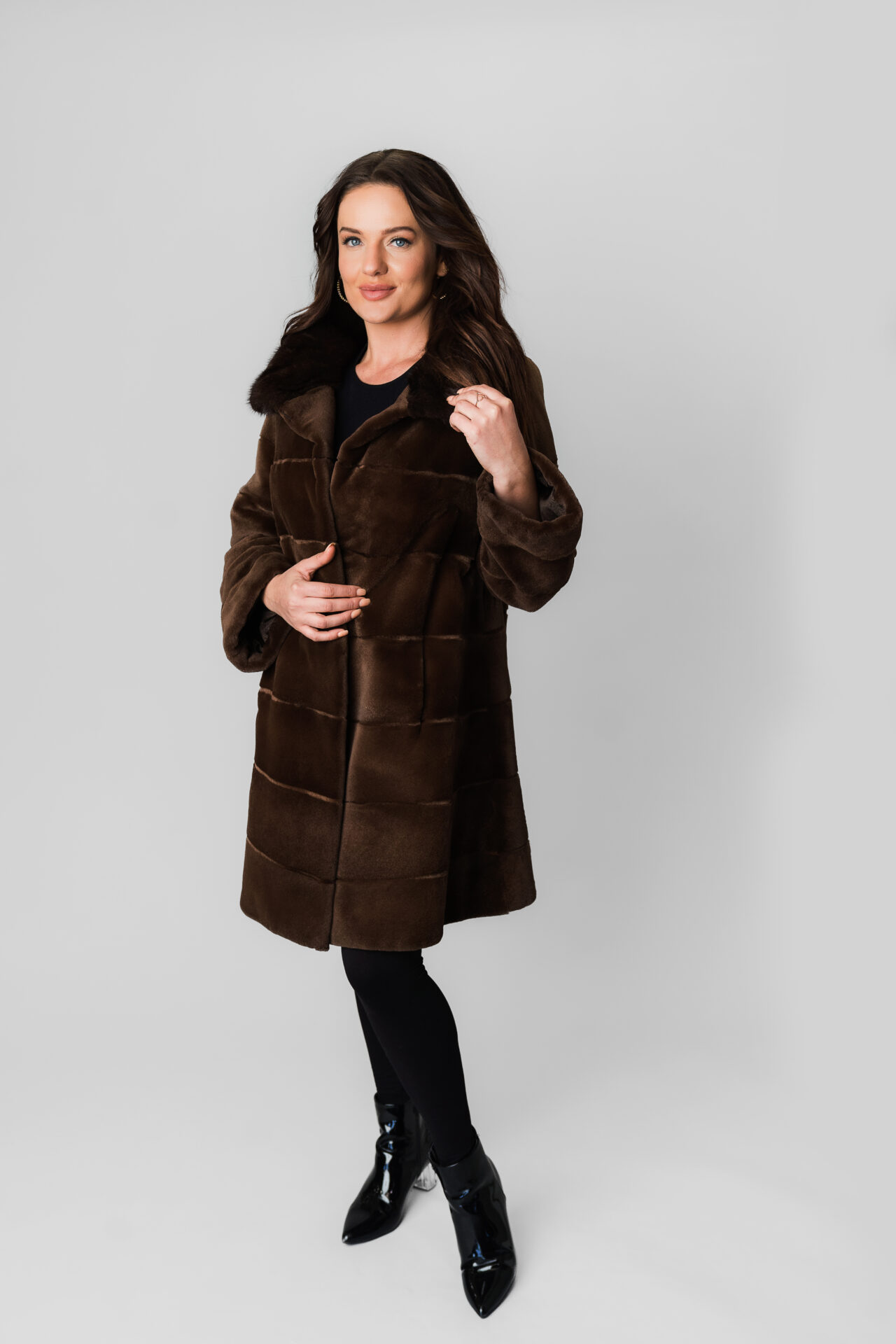 A Woman Wearing a Velvet Texture Brown Knee Length Coat