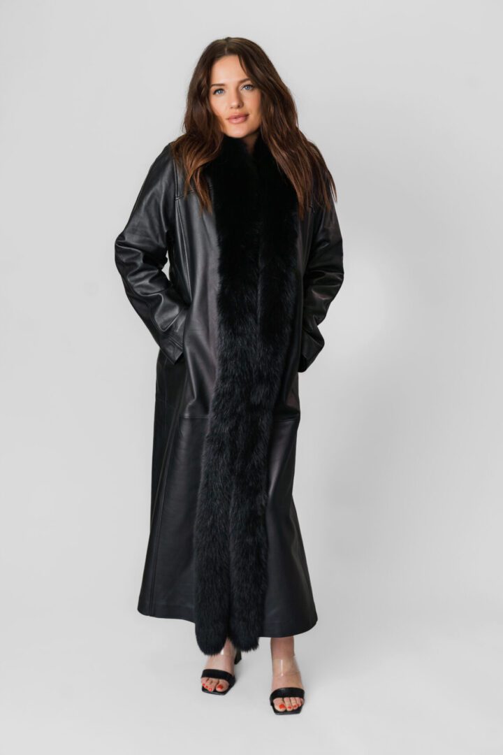 A Long Ankle Length Black Leather Jacket With Fur Lining