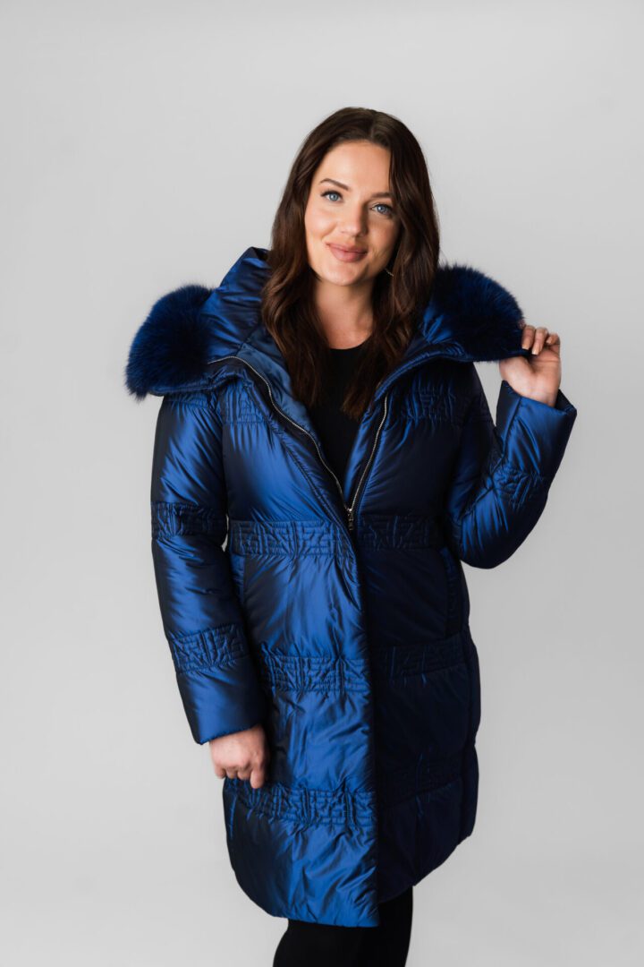 A Blue Color Puffer Jacket With Fur Ending