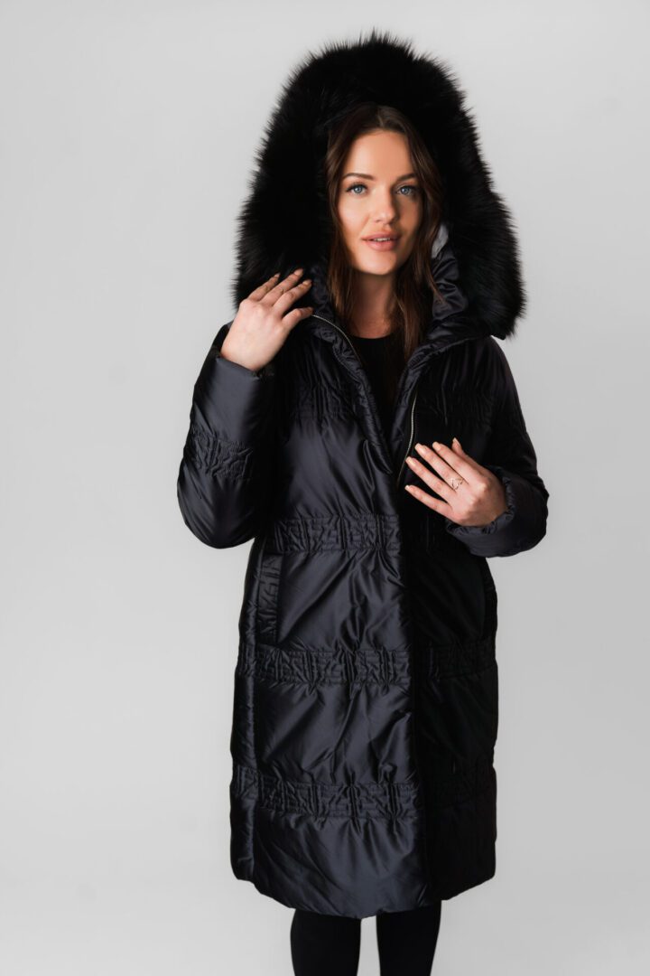 A Long Black Puffer Jacket With Fur Ends at the Hood