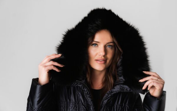 A Woman in a Long Puffer Jacket With Fur Ends at Hood